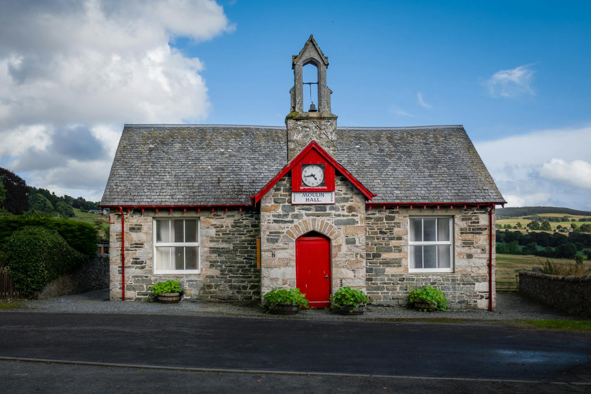 Historic stone building with red accents in Moulin, Perth and Kinross, Scotland.