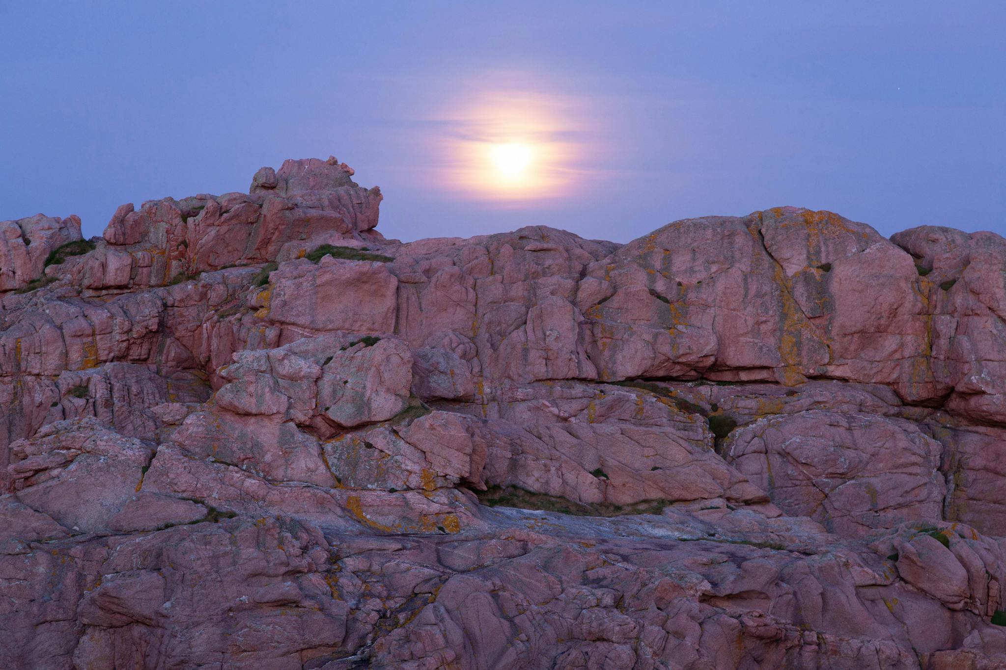 Sunset view of the stunning pink granite rock formations in Perros-Guirec, Brittany, France.